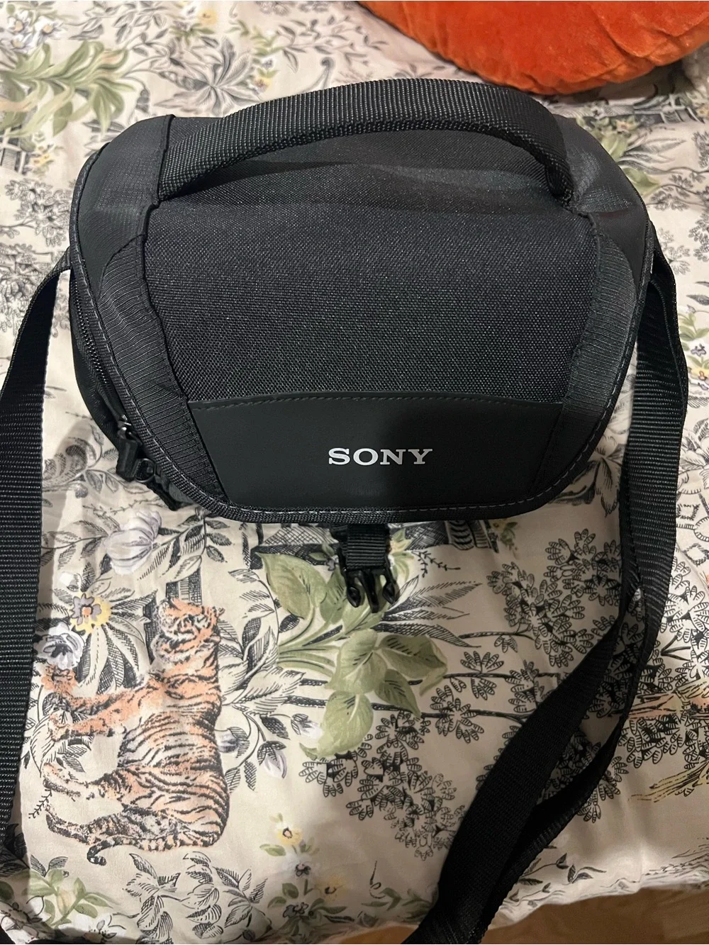 Sony Black Alpha Mirrorless A6100 Camera Body with Black Strap and Orange Accent